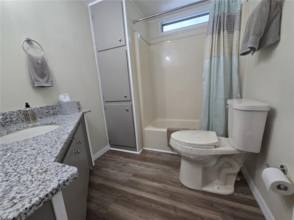 3935 Parway Road, Unit 1322 Zellwood, FL 32798 - Photo 19 of 28 a bathroom with a granite countertop sink toilet and shower
