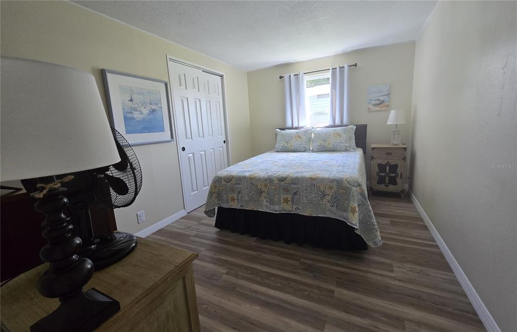 3935 Parway Road, Unit 1322 Zellwood, FL 32798 - Photo 20 of 28 a room with a bed and wooden floor