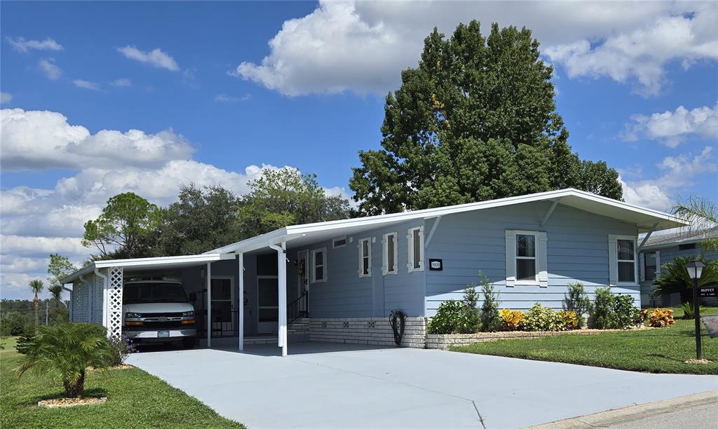 3935 Parway Road, Unit 1322 Zellwood, FL 32798 - Photo 2 of 28 a front view of a house with a yard