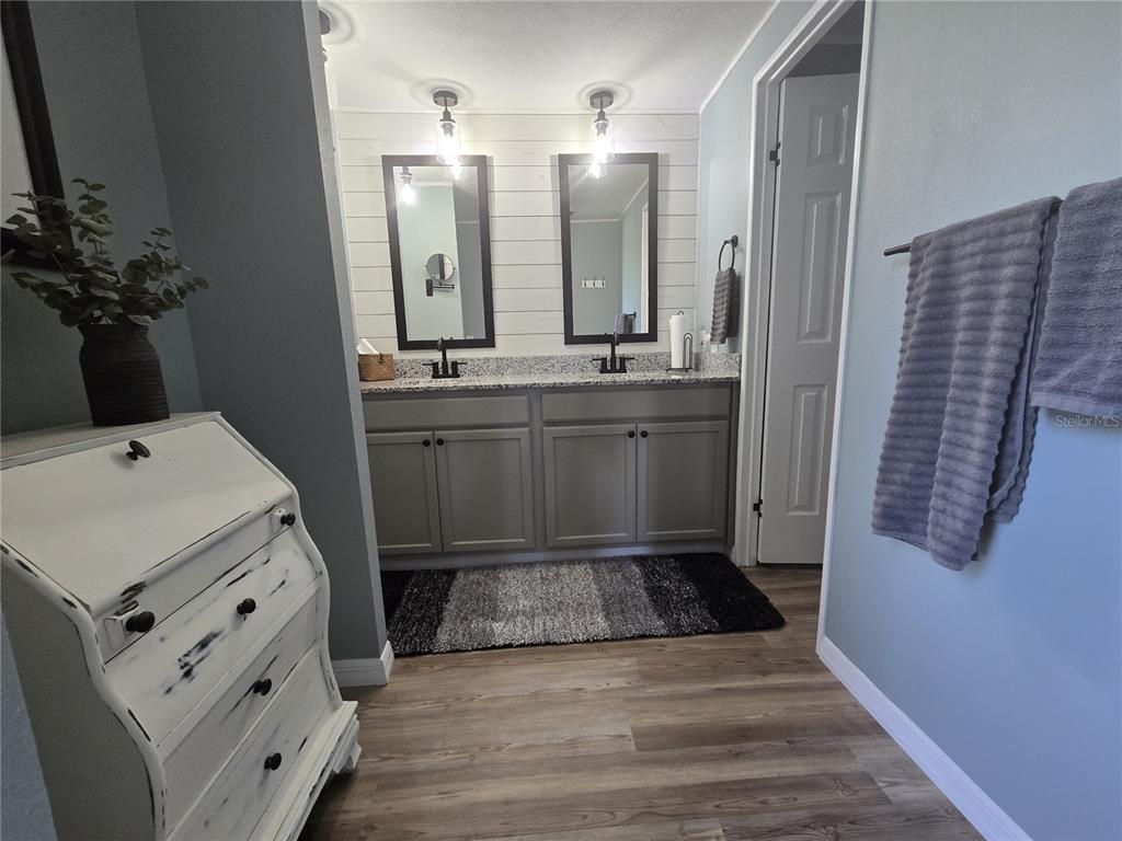 3935 Parway Road, Unit 1322 Zellwood, FL 32798 - Photo 22 of 28 a spacious bathroom with a double vanity sink and a mirror