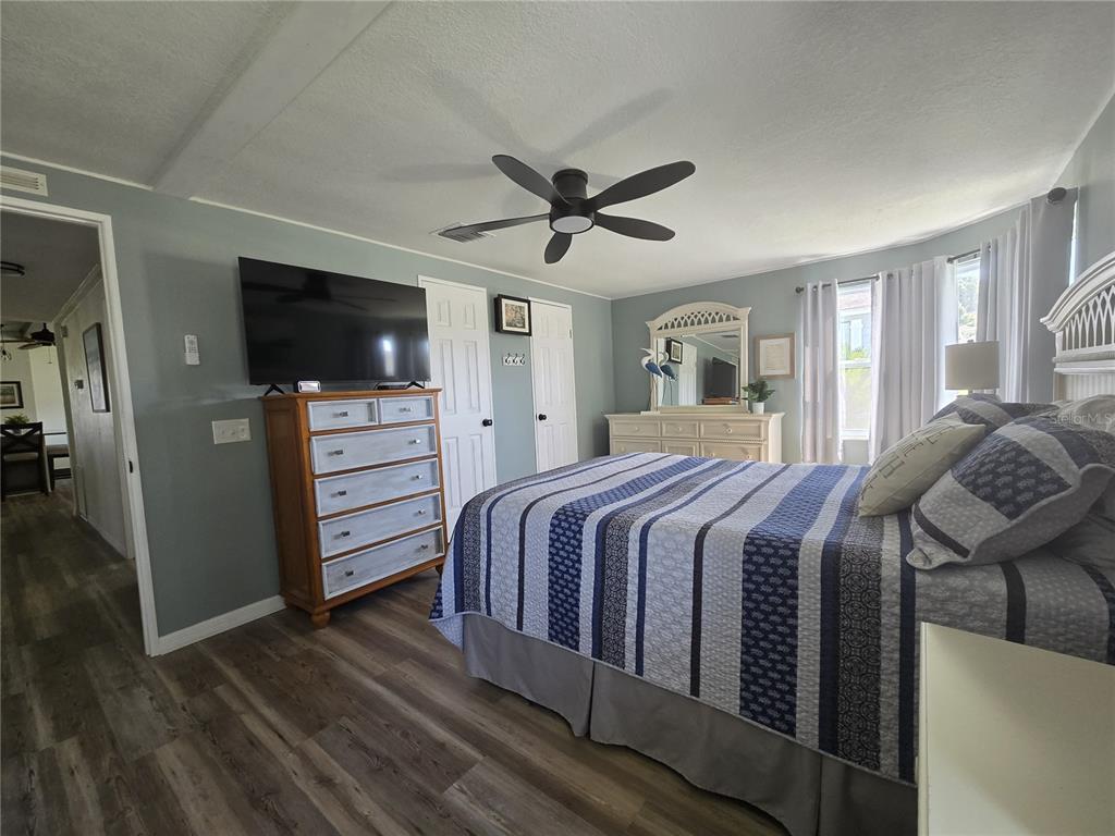 3935 Parway Road, Unit 1322 Zellwood, FL 32798 - Photo 27 of 28 a bedroom with a bed and a flat screen tv