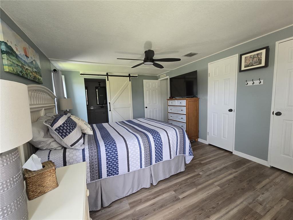 3935 Parway Road, Unit 1322 Zellwood, FL 32798 - Photo 28 of 28 a bedroom with a bed and wooden floor