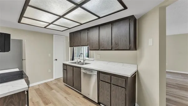 a kitchen with a sink appliances and cabinets