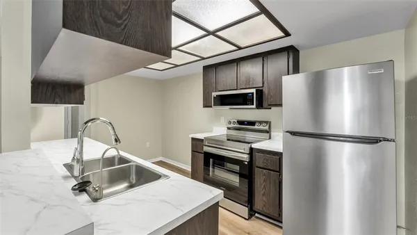 a kitchen with stainless steel appliances a refrigerator and a sink