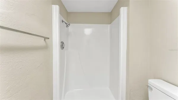 a bathroom with a shower and a toilet