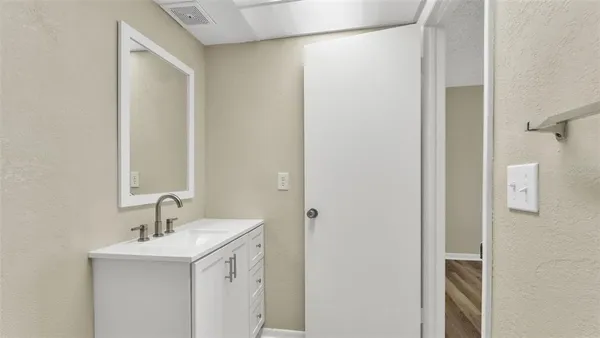 a bathroom with a sink and mirror
