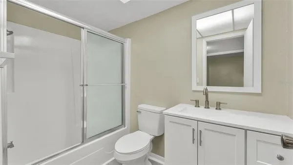 a bathroom with a sink a toilet and vanity