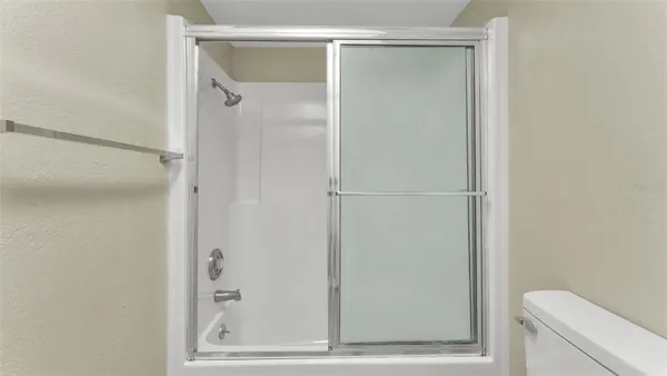 a bathroom with a glass shower door