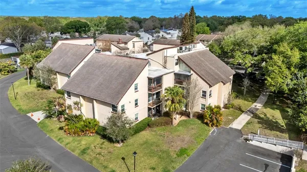 an aerial view of a house with a yard