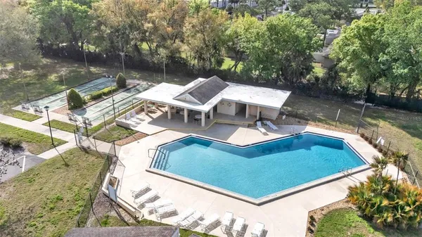 a view of a swimming pool with lounge chairs in the patio