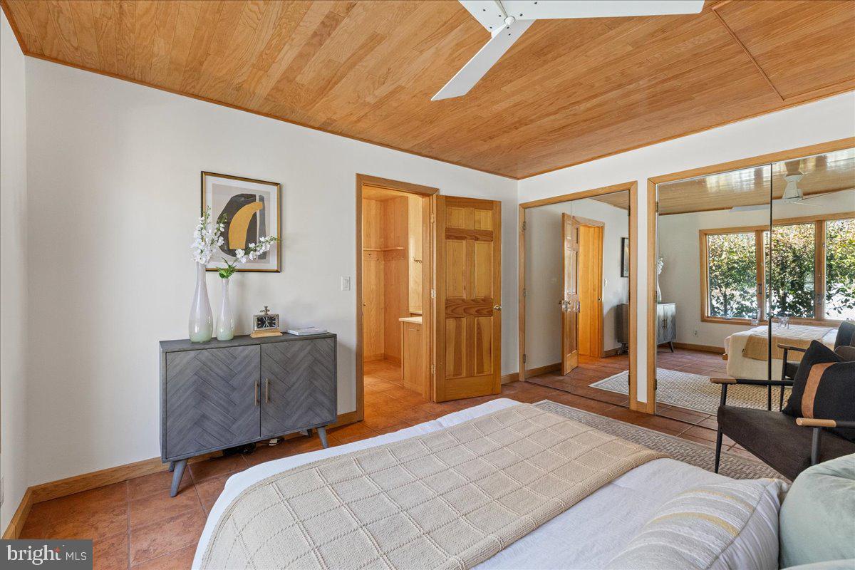 165 Heather Lane Princeton, NJ 08540 - Photo 16 of 28 a bedroom with a bed and large windows