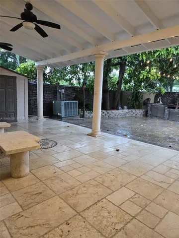 a view of a backyard with sitting area and garden
