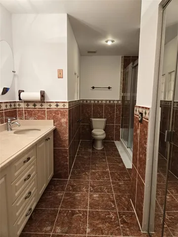 a bathroom with a sink toilet and shower