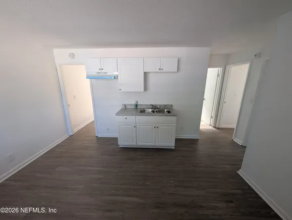 a spacious bathroom with a sink a mirror and shower