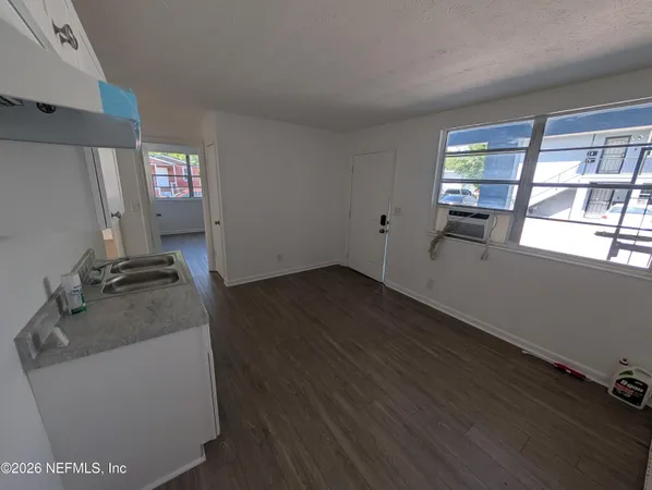 a room with window wooden floor and glass door
