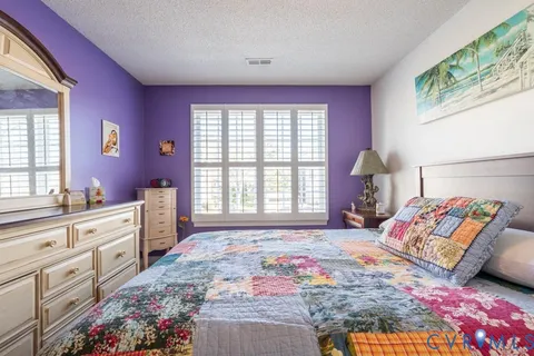 a bedroom with a bed and a dresser in it
