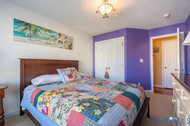 a bedroom with bed and wooden floor