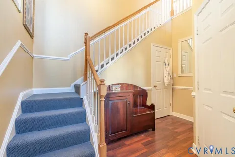 a view of entryway and hall with wooden floor