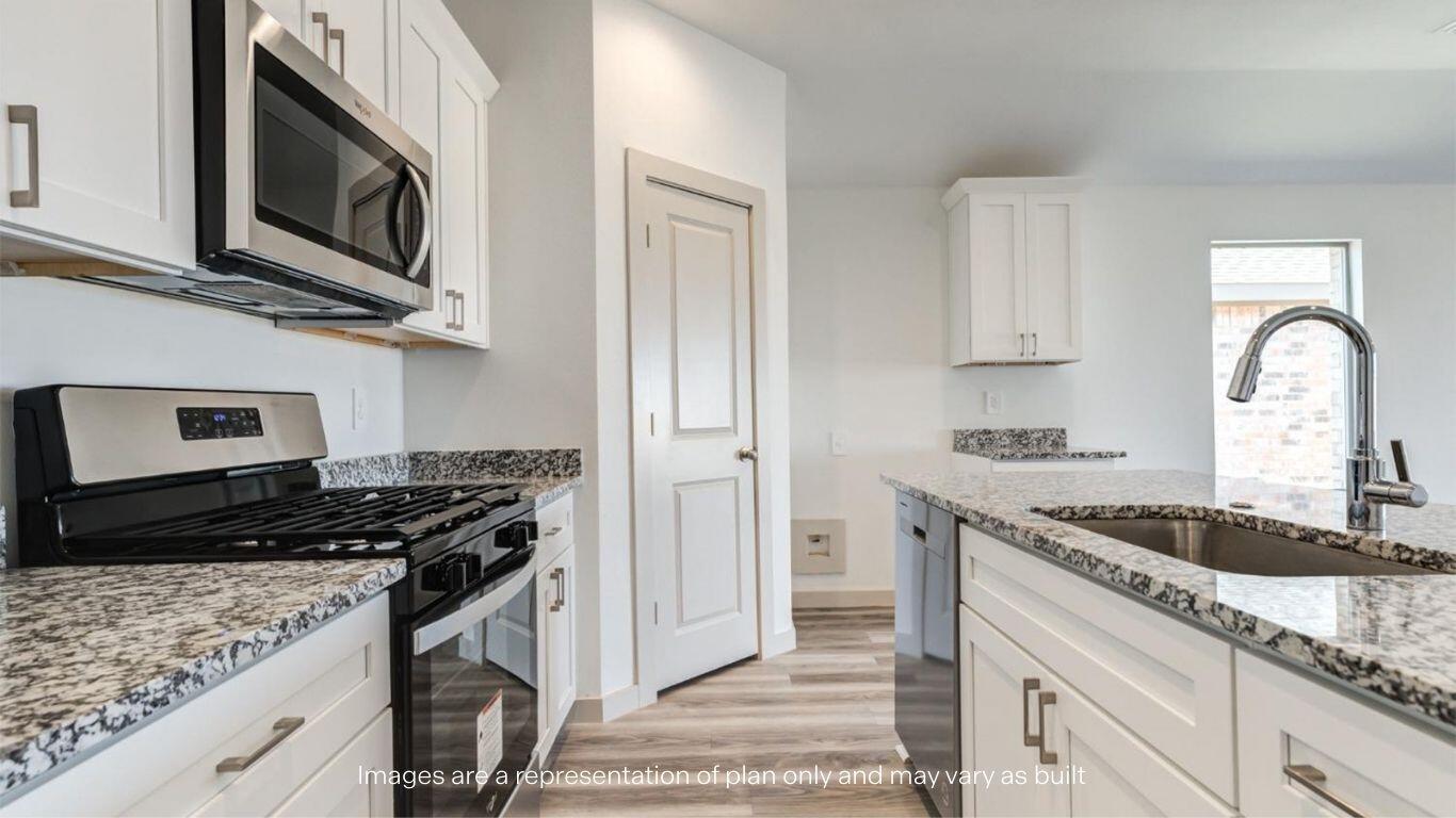 2234 150th Place Lubbock, TX 79423 - Photo 4 of 22 a kitchen with granite countertop stainless steel appliances a stove a sink and cabinets