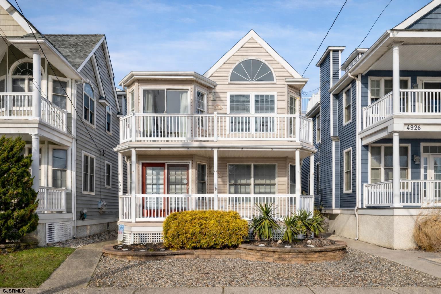 4930 Asbury Avenue, Unit 2 Ocean City, NJ 08226 - Photo 1 of 25 a front view of a house with a yard