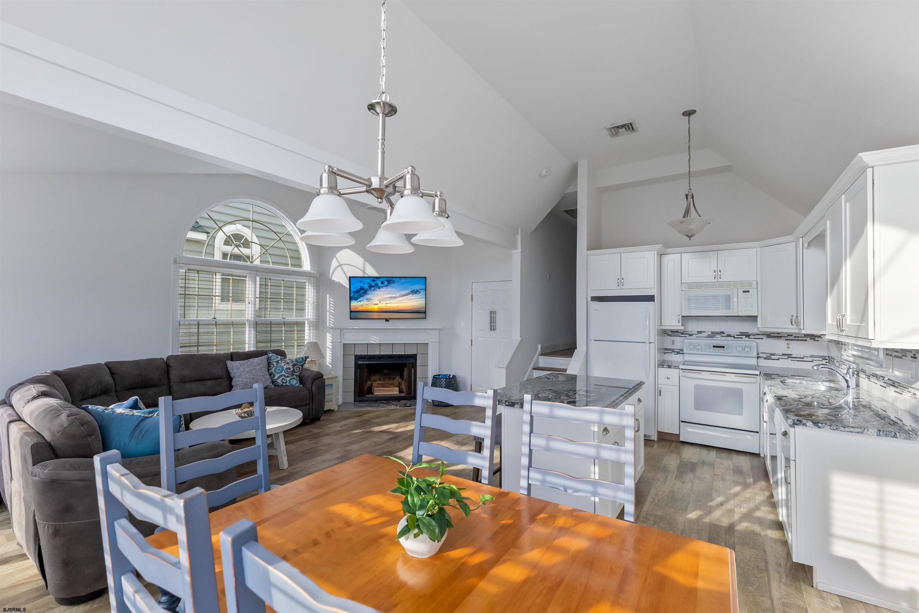 4930 Asbury Avenue, Unit 2 Ocean City, NJ 08226 - Photo 11 of 25 a living room with fireplace furniture and a chandelier