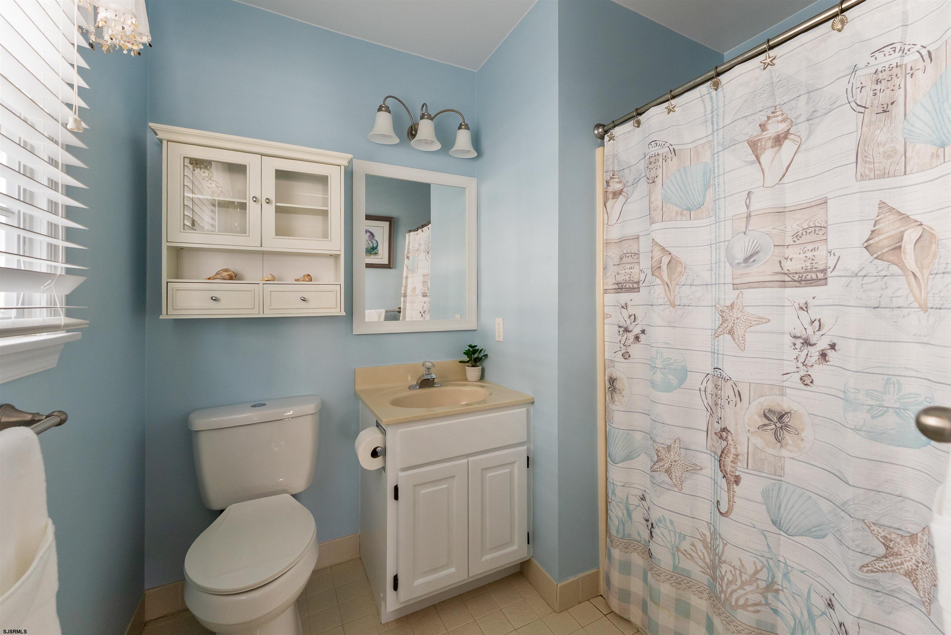 4930 Asbury Avenue, Unit 2 Ocean City, NJ 08226 - Photo 21 of 25 a white toilet sitting next to a bathroom sink