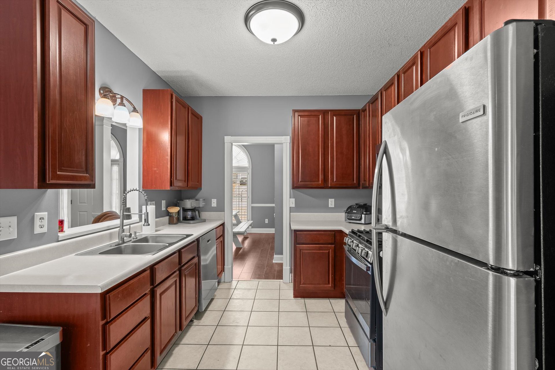 238 James Allen Place Temple, GA 30179 - Photo 14 of 42 a kitchen with a sink refrigerator and cabinets