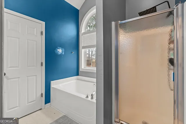 a bathroom with a bathtub and shower