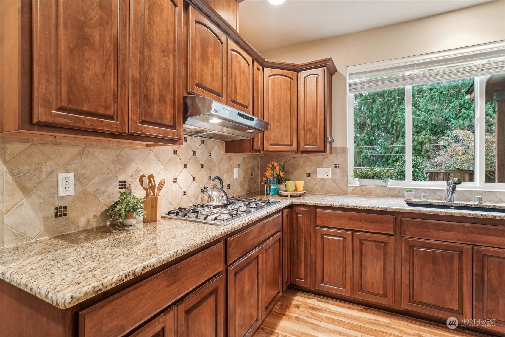 3122 223rd Street Southeast Bothell, WA 98021 - Photo 9 of 36 a kitchen with granite countertop stainless steel appliances a sink window and cabinets