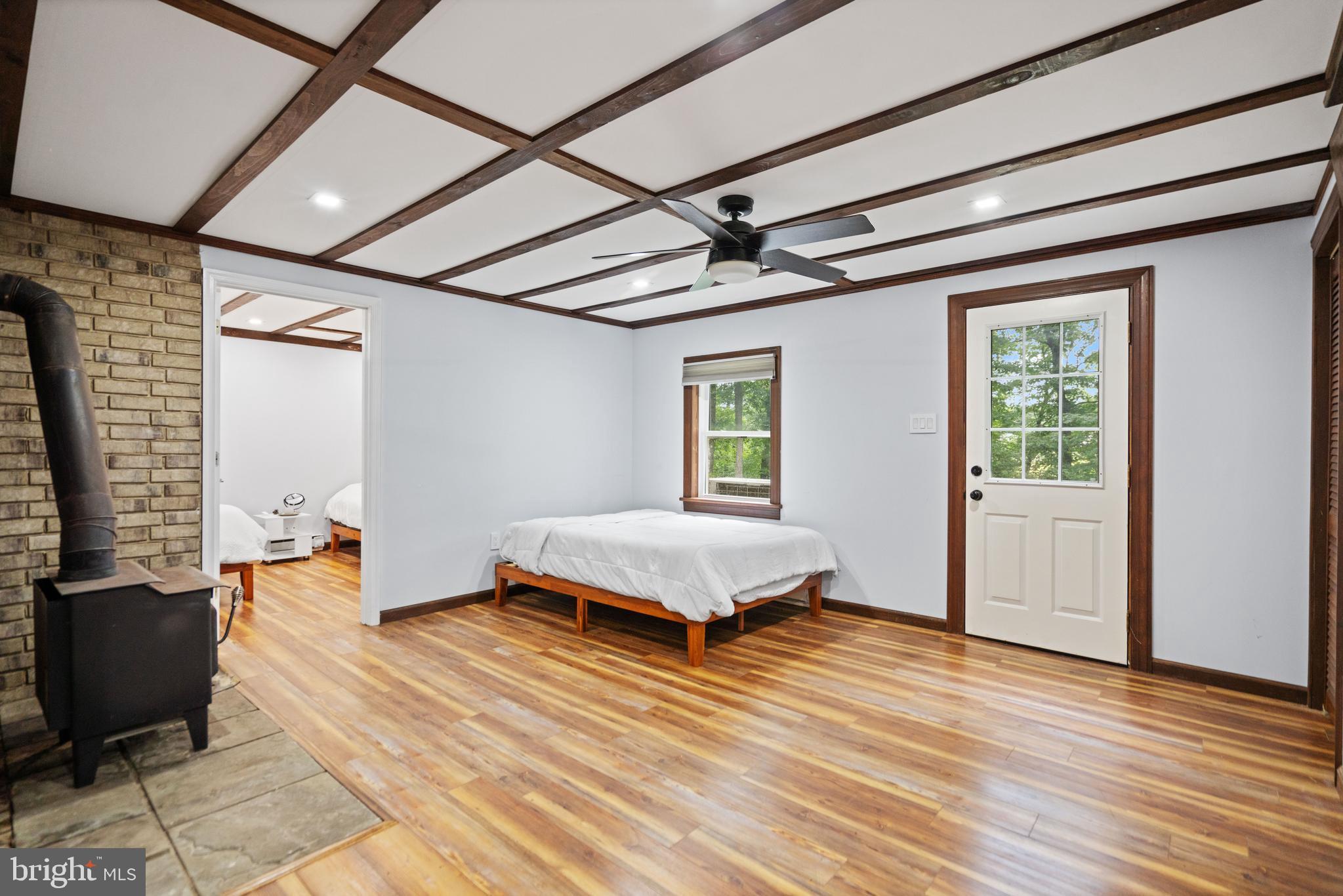 265 Slate Lane Stephenson, VA 22656 - Photo 22 of 29 a spacious bedroom with a bed and wooden floor