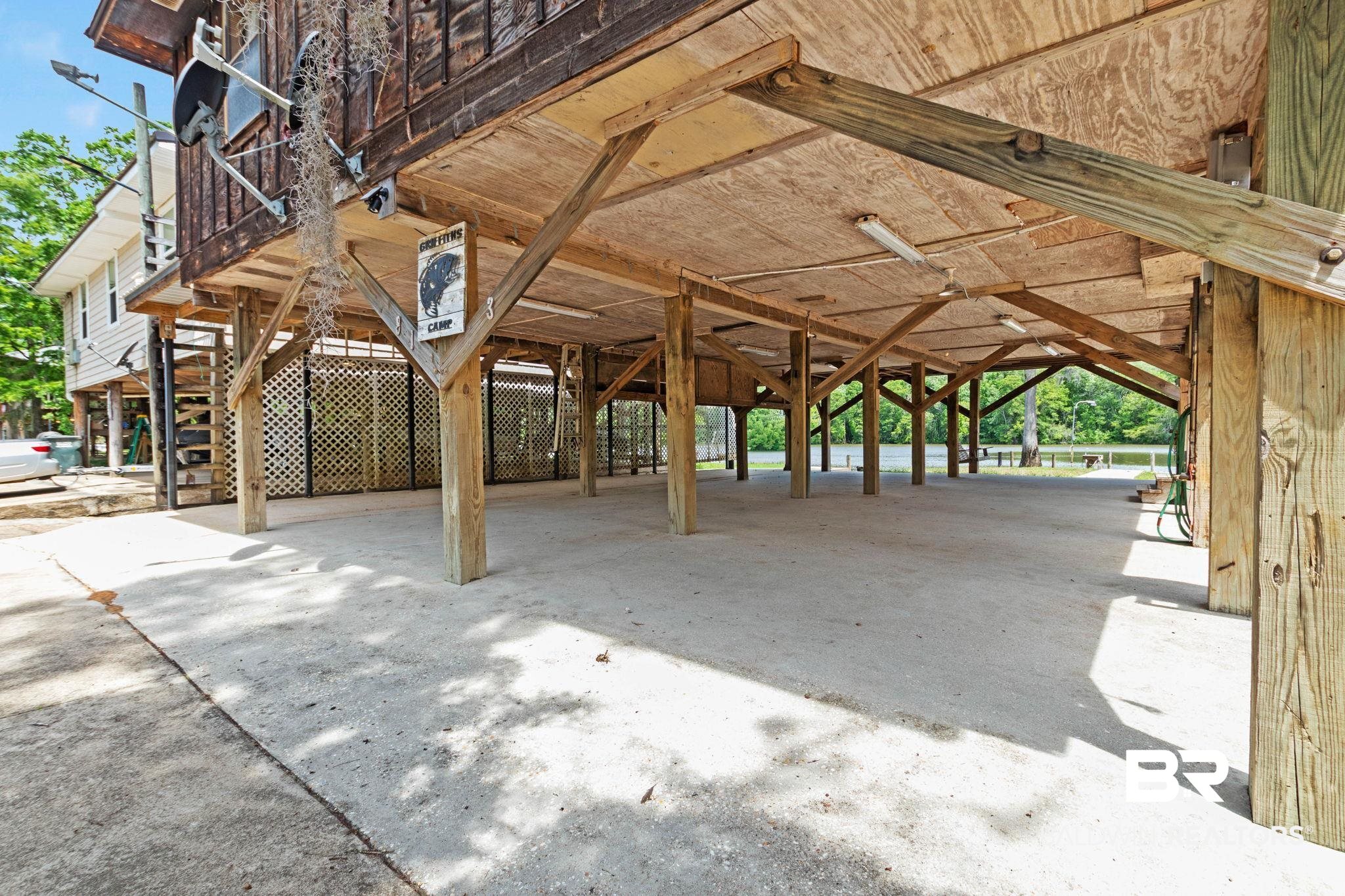 8153 Bryant's Lndg Road Stockton, AL 36579 - Photo 64 of 87 Expansive covered under-house area featuring a concrete slab and exposed wood framing