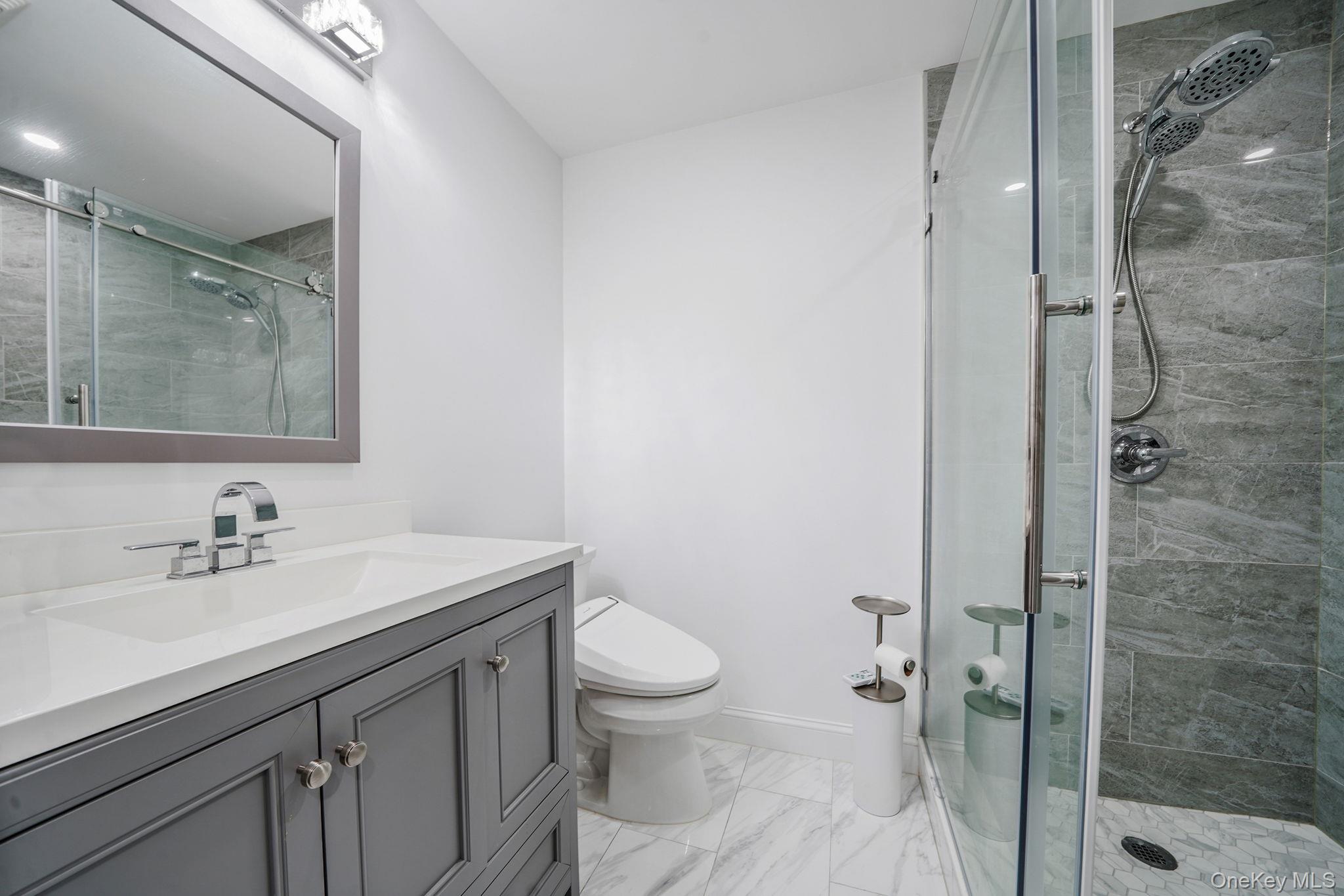 122 4th Street St. James, NY 11780 - Photo 18 of 36 a bathroom with a sink toilet and shower