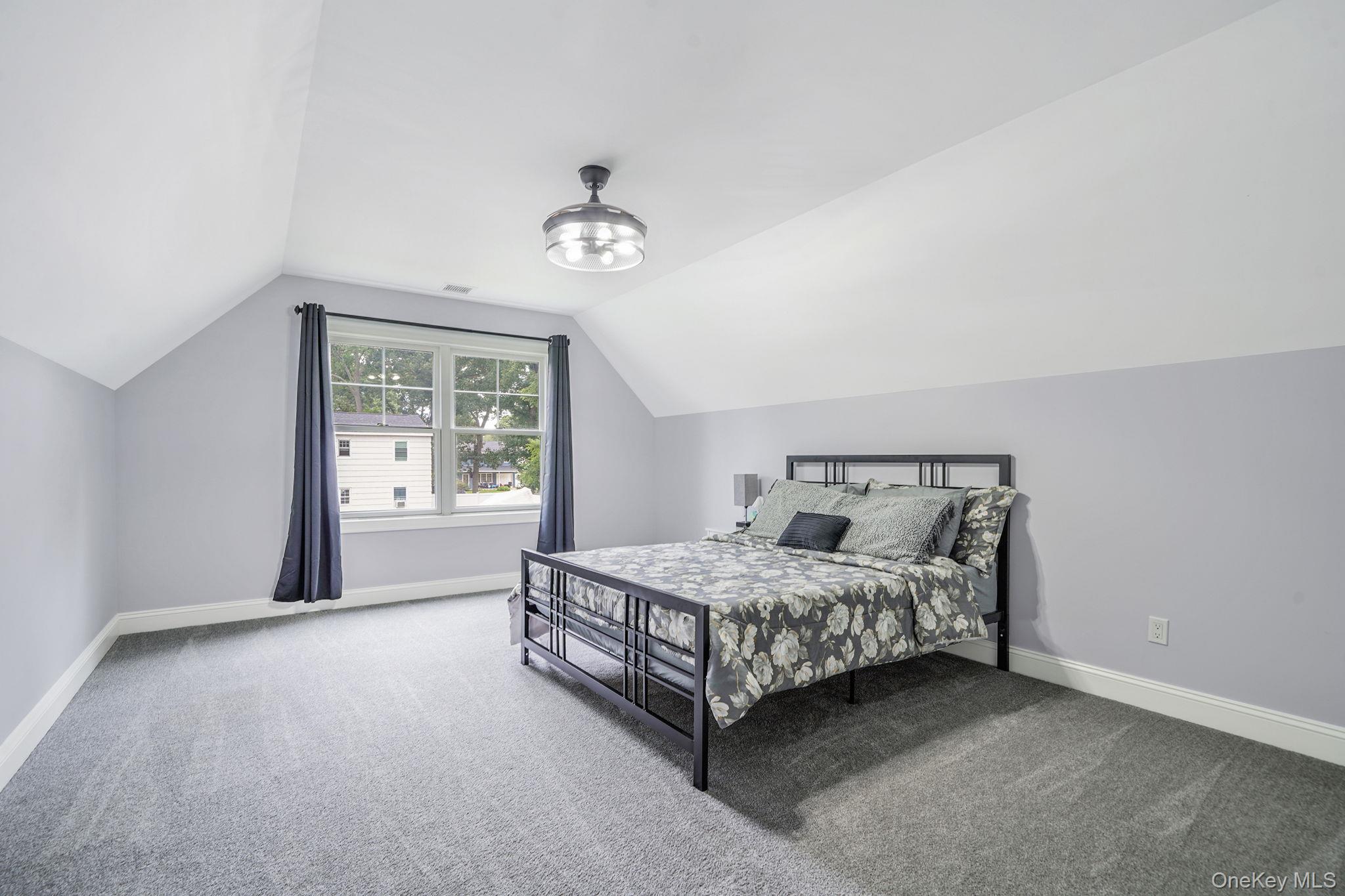 122 4th Street St. James, NY 11780 - Photo 22 of 36 a bedroom with a bed painting and a window