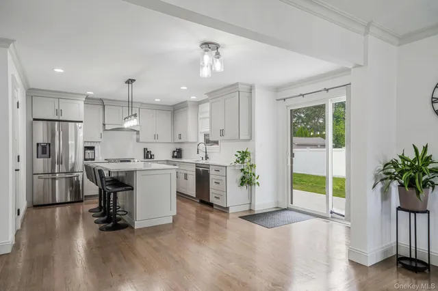 a kitchen with a refrigerator a sink and a stove top oven