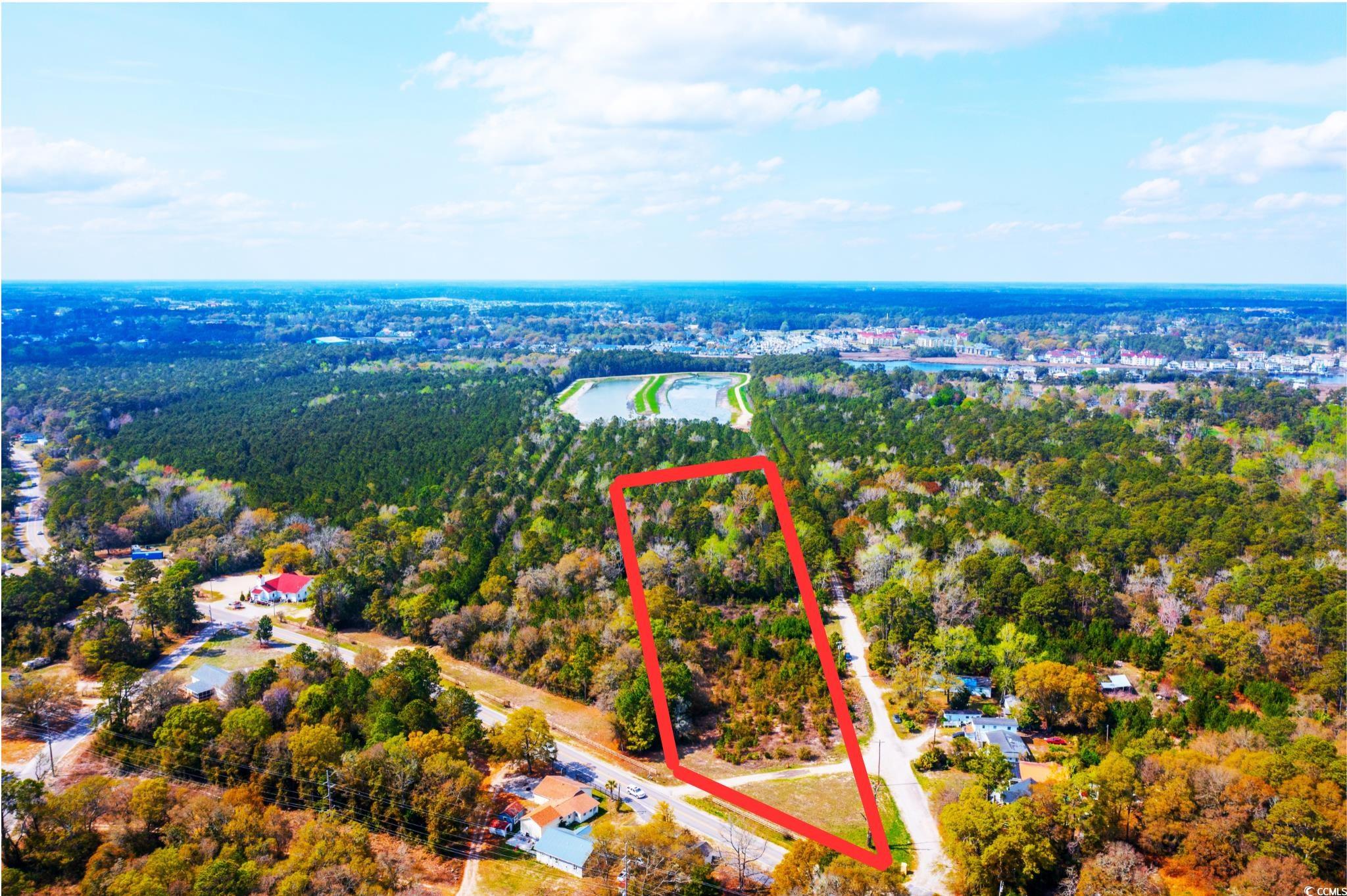4675 Little River Neck Road North Myrtle Beach, SC 29582 - Photo 3 of 23 Bird's eye view featuring a wooded view