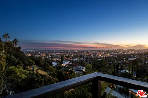 a large bathroom with a glass shower door and a sink