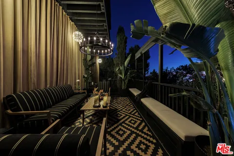 a living room with furniture fireplace and flat screen tv