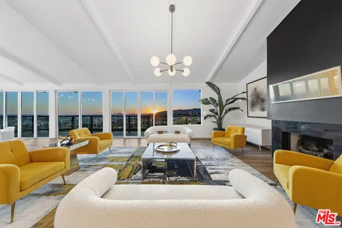 a living room with furniture a flat screen tv and a floor to ceiling window