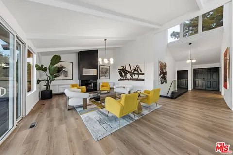 a kitchen with a table chairs and cabinets