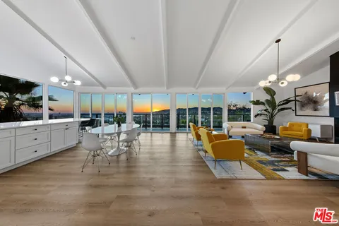 a spacious kitchen with a sink and chandelier