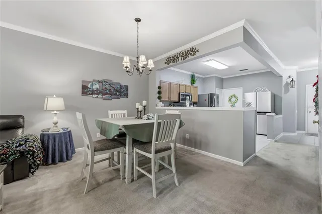 a view of a dining room with furniture and chandelier