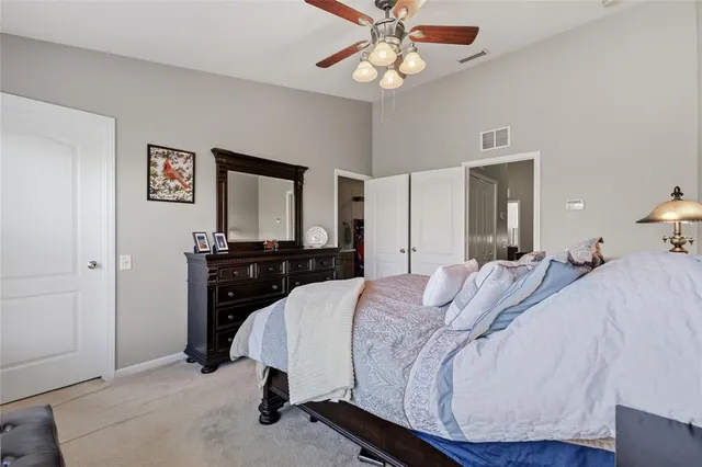 a bedroom with a bed and a mirror