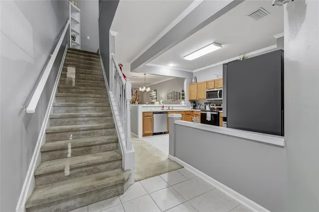 a view of kitchen with sink and refrigerator