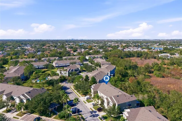 an aerial view of residential houses with outdoor space