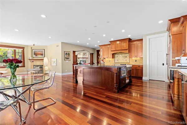 a living room with fireplace furniture and a wooden floor