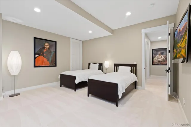 a bedroom with a large bed and a chandelier