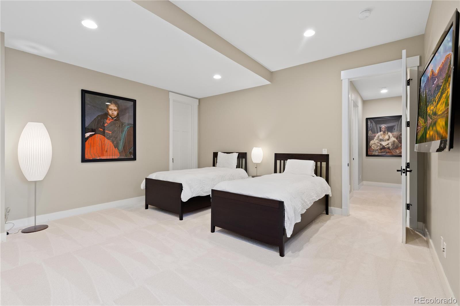 800 Grant Place Boulder, CO 80302 - Photo 25 of 50 a spacious bedroom with a bed and painting on the wall
