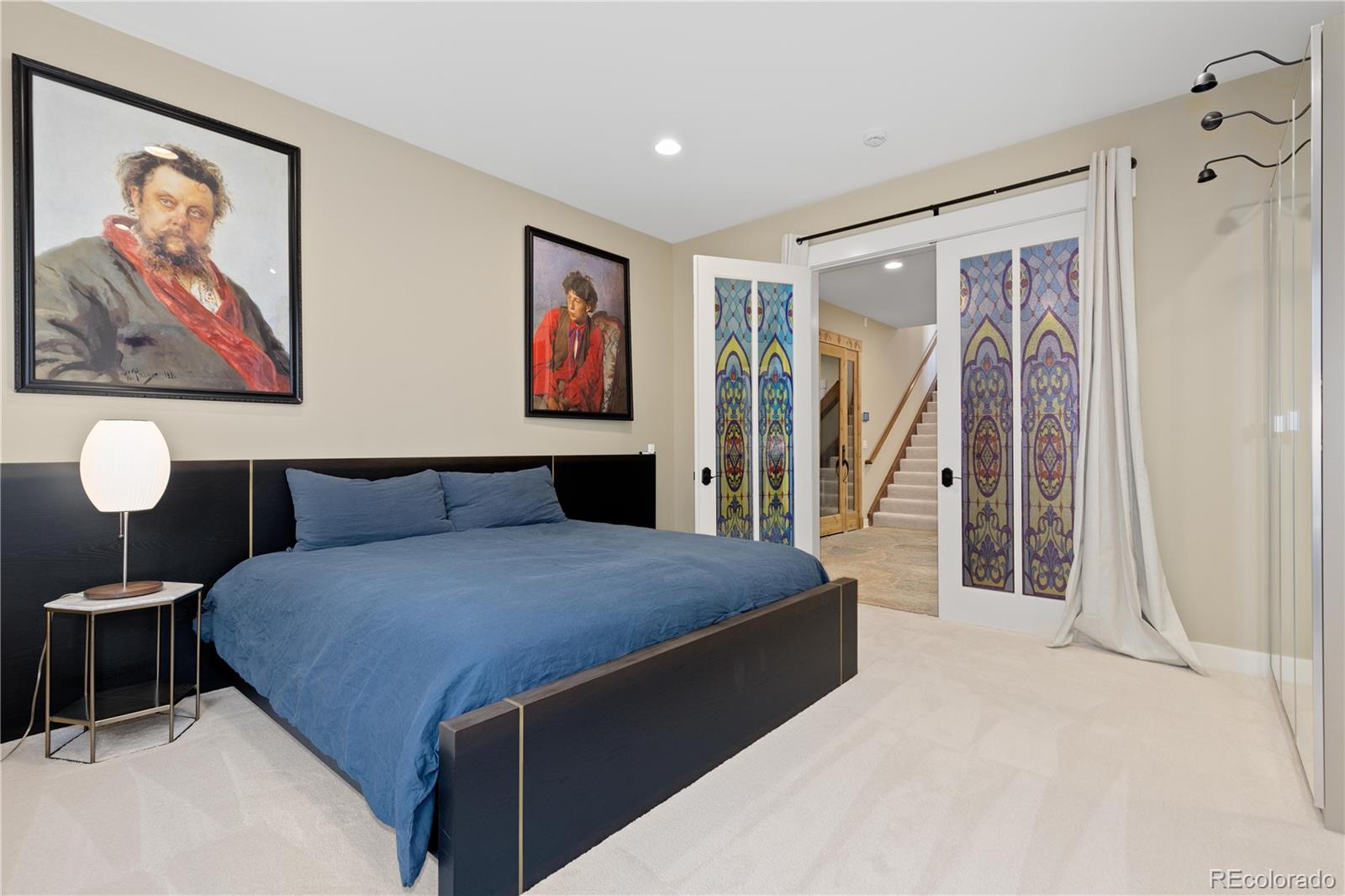 800 Grant Place Boulder, CO 80302 - Photo 26 of 50 a bedroom with a large bed and a chandelier