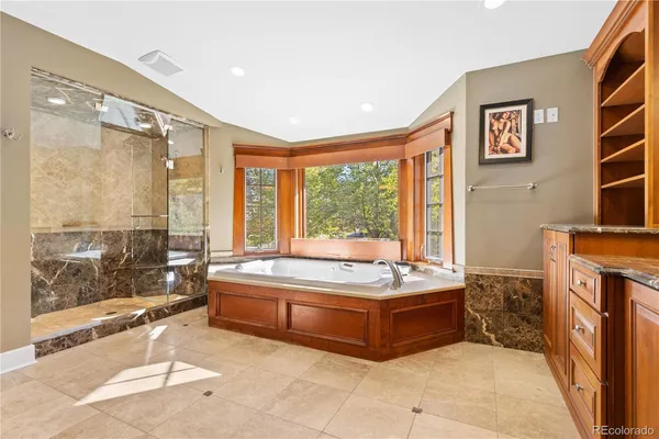 a bathroom with a tub sink and mirror