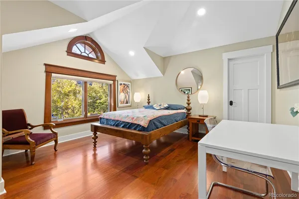 a bathroom with a granite countertop sink a toilet and a mirror